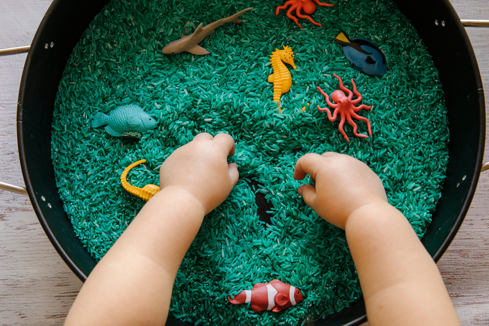 child's hands and toys