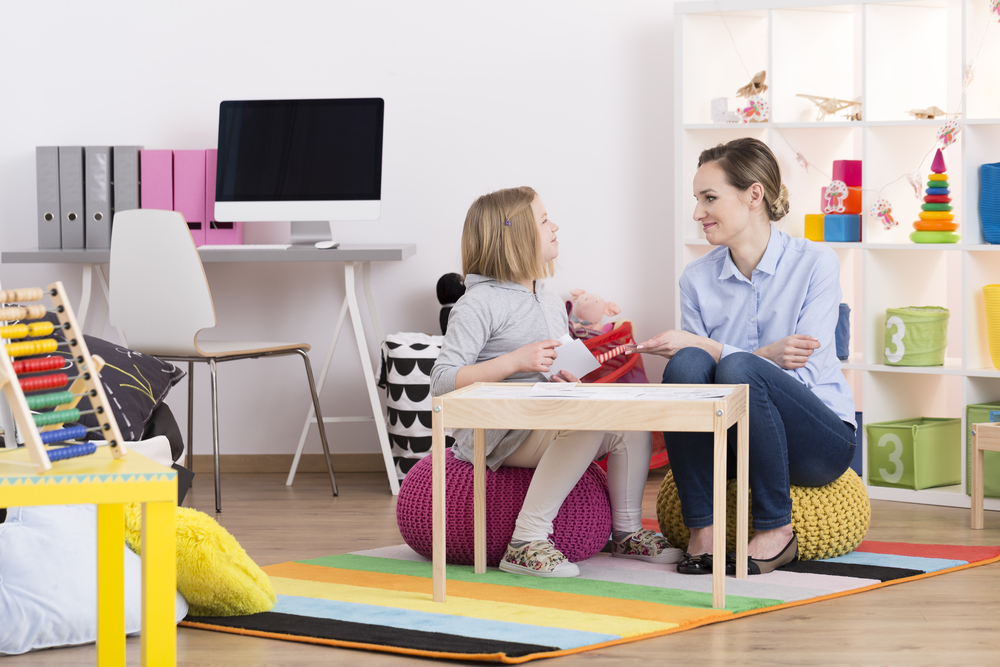 women and girl in playroom